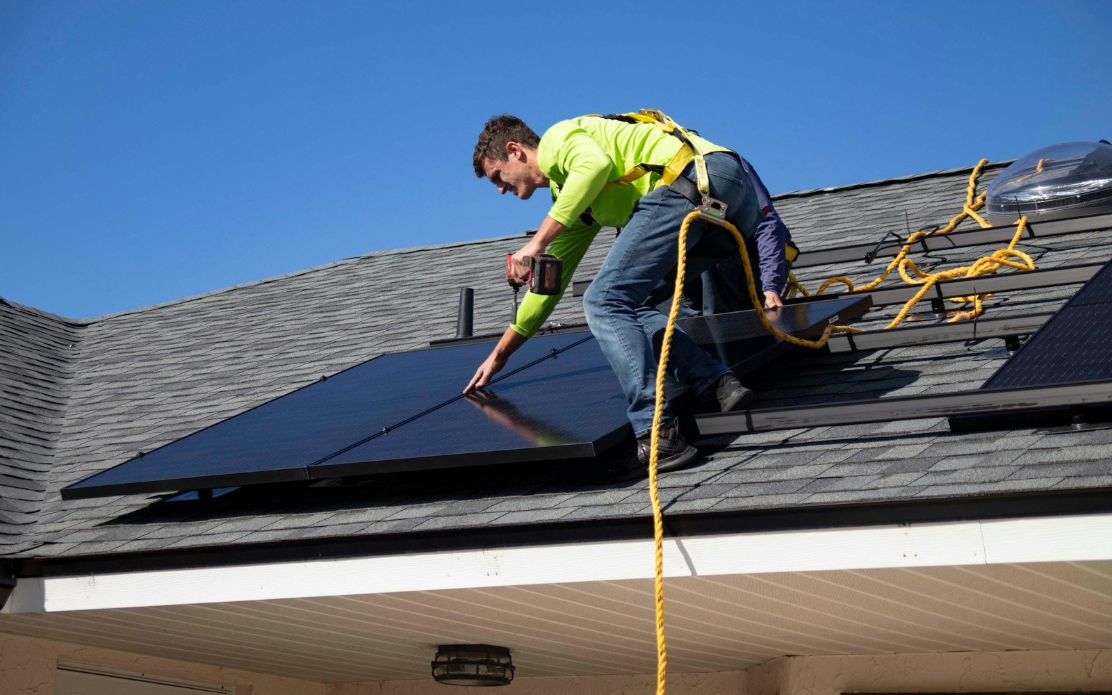Installer fitting solar panels on a roof